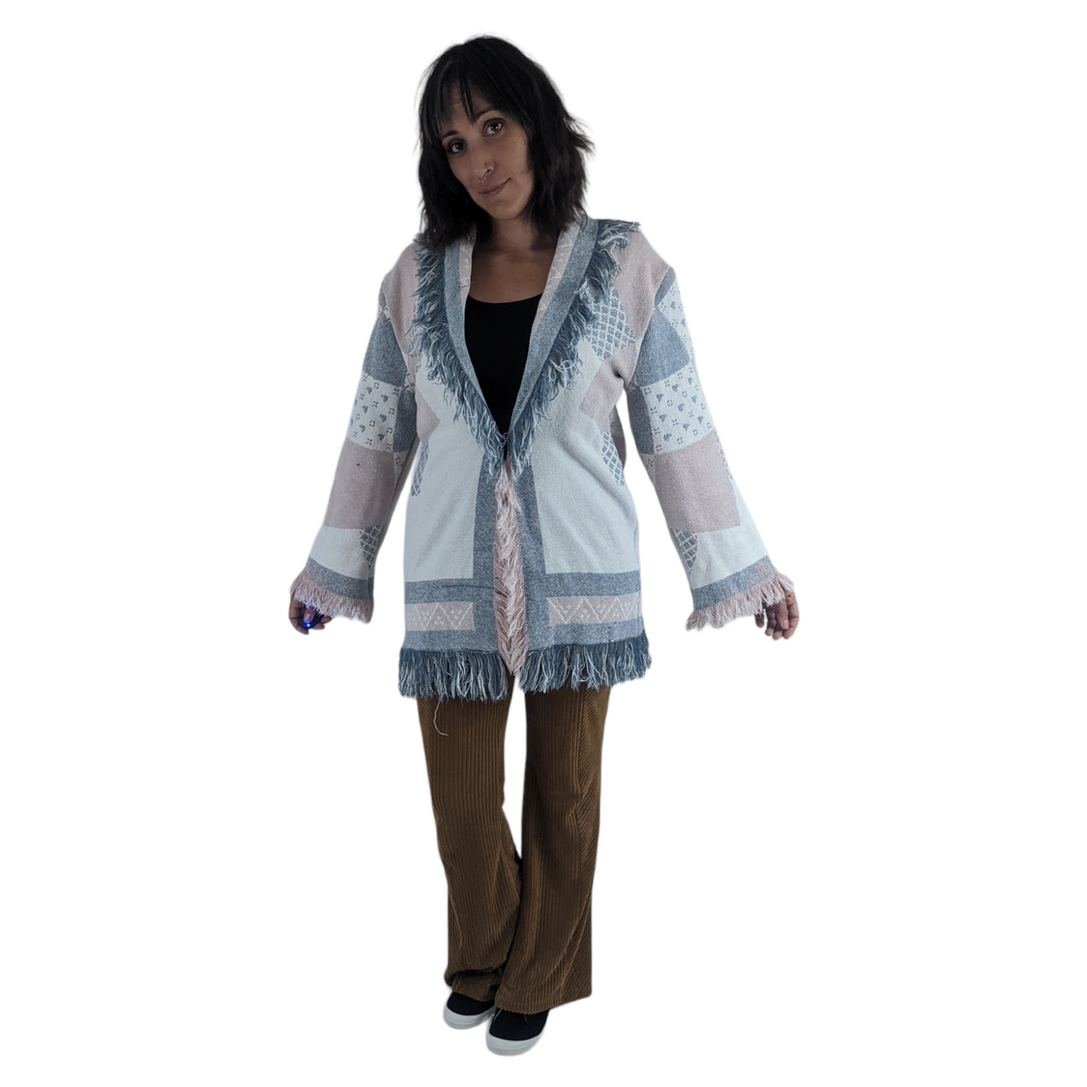 a woman in a white jacket and brown pants.