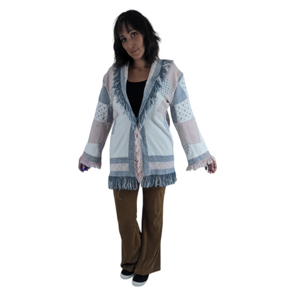a woman in a white jacket and brown pants.