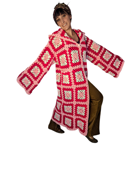 a woman in a red and white crocheted sweater.