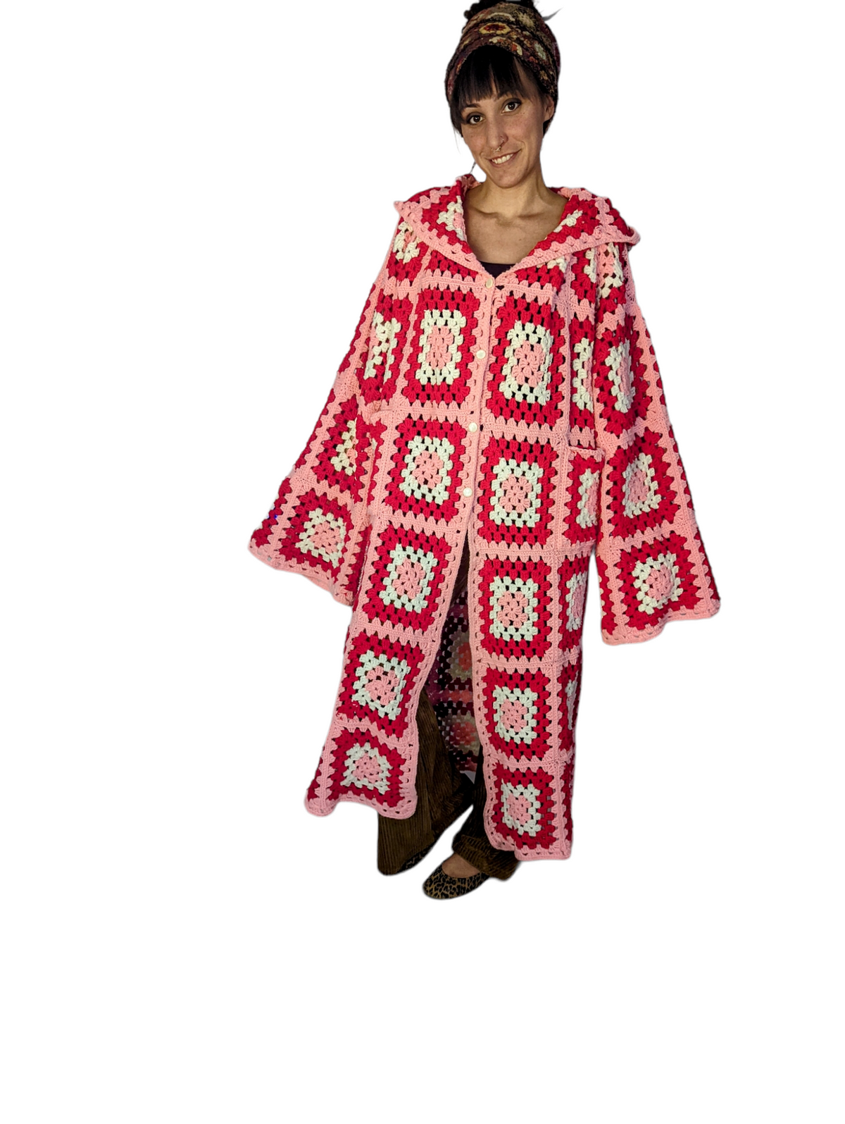 a woman wearing a red and white crocheted sweater.