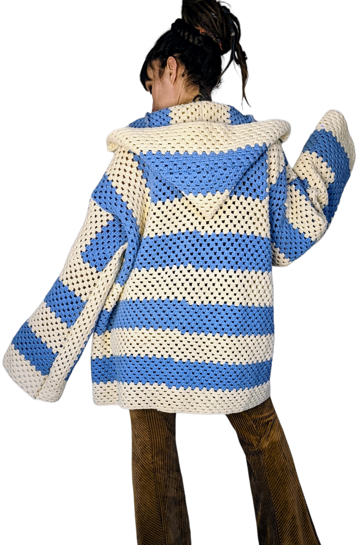 a woman is wearing a blue and white sweater.