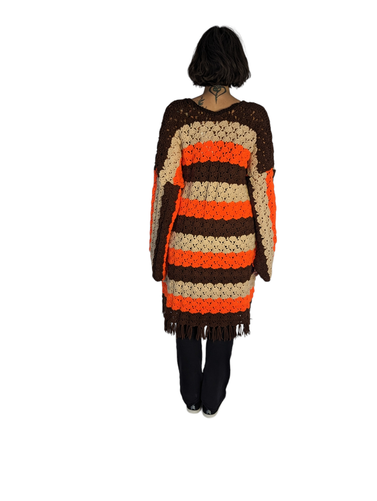 Rear view of model wearing retro crochet cardigan.