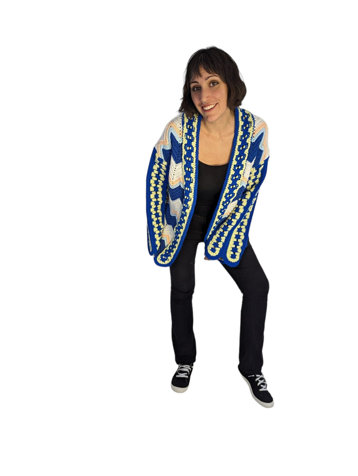 Front view of model displaying upcycled crochet afghan cardigan.