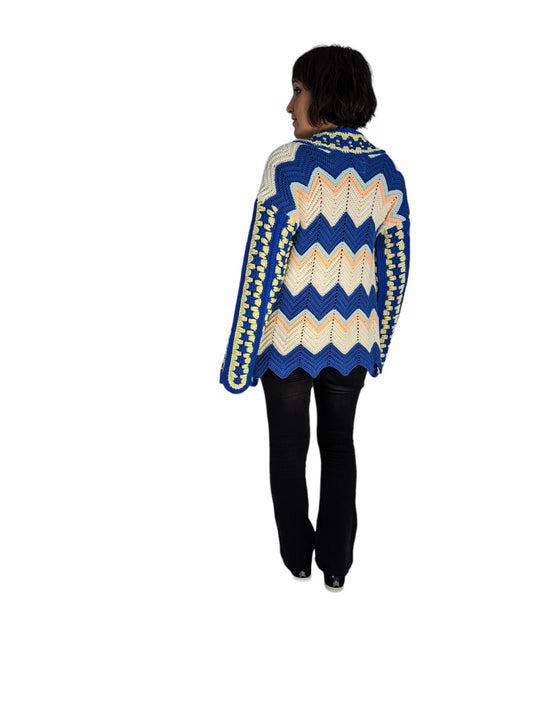 Rear view of woman wearing crochet cardigan.