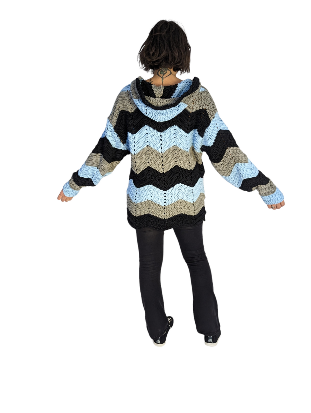 Rear view of model wearing blue crochet hoodie.