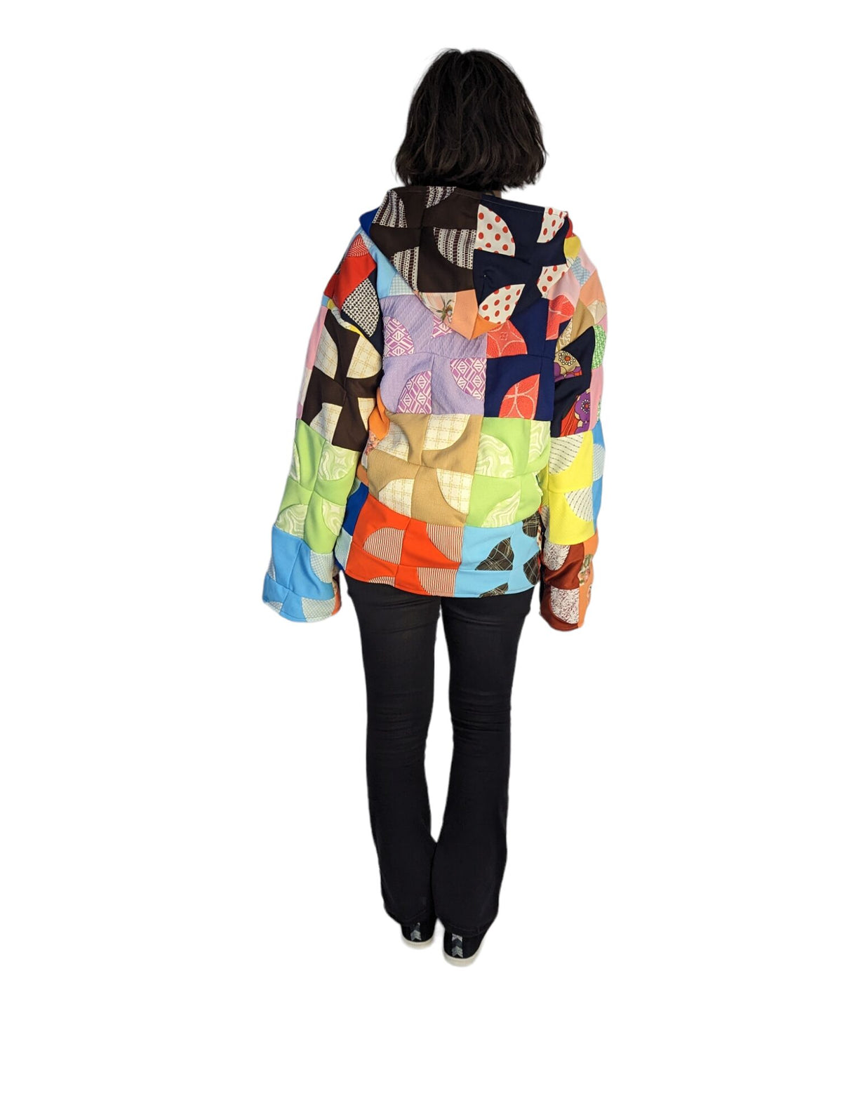 Rear view of model wearing vintage patchwork quilt coat.