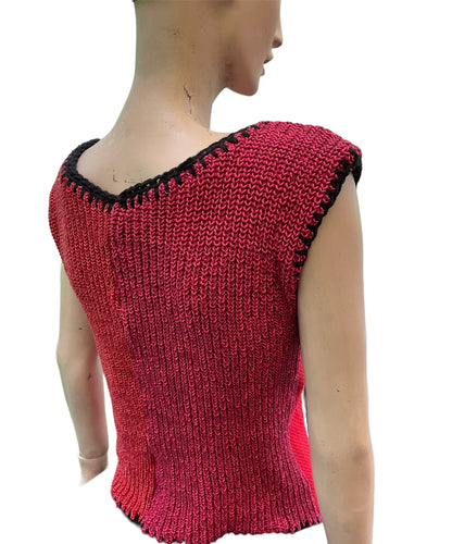 a mannequin wearing a red and black knitted top.