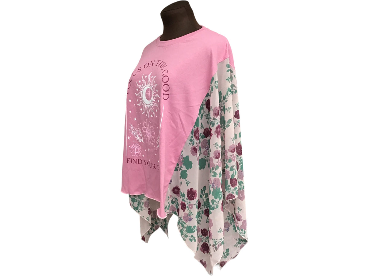 A mannequin wearing a pink t - shirt with flowers on it.