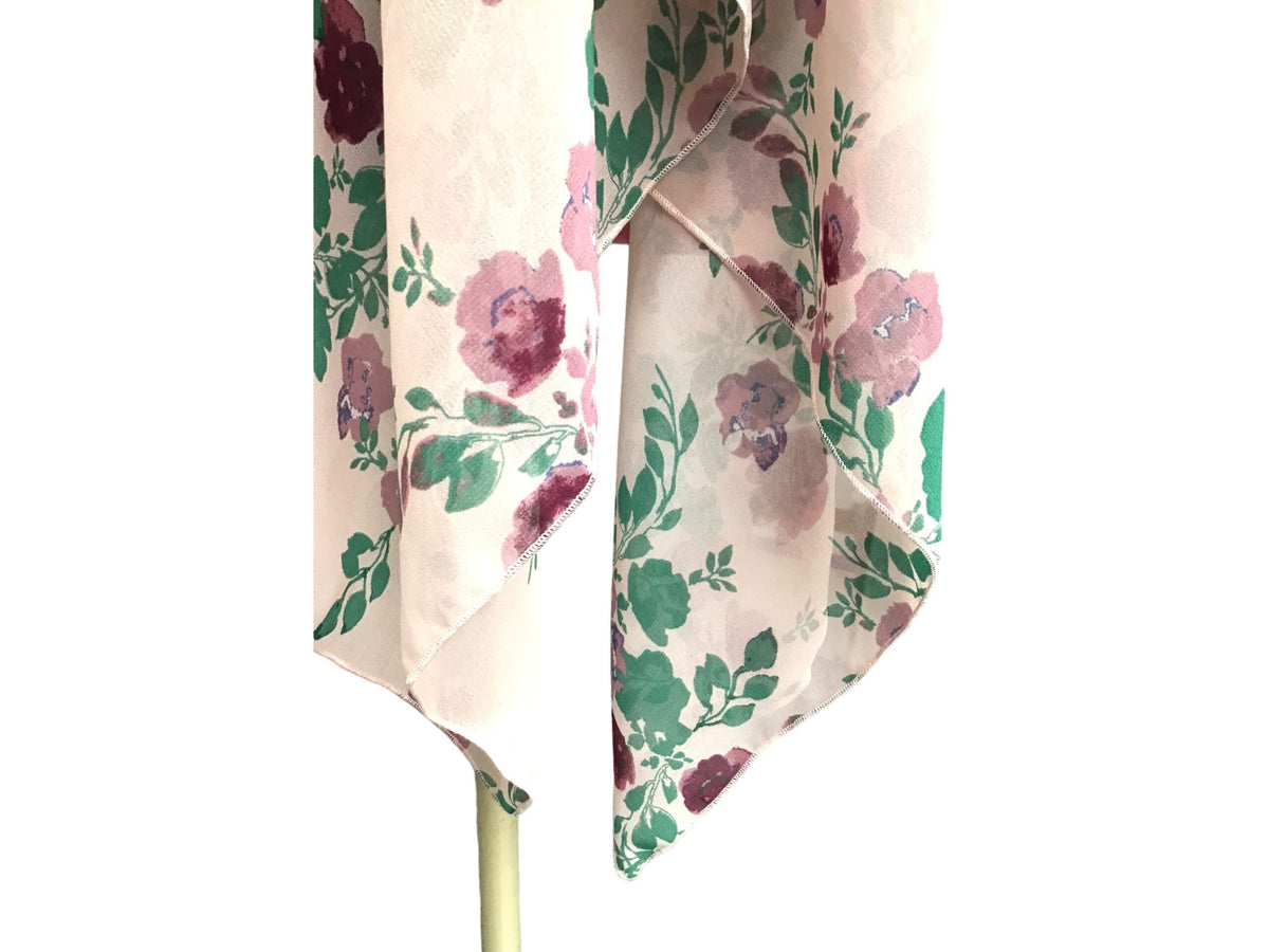 A pink and purple umbrella with flowers on it.