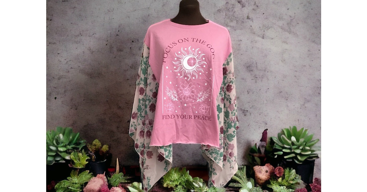 A pink t - shirt on a mannequin with plants.