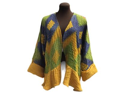 A yellow, blue and green kimono on a mannequin.