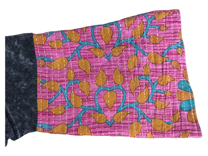 A pink and blue pillow with a floral pattern.