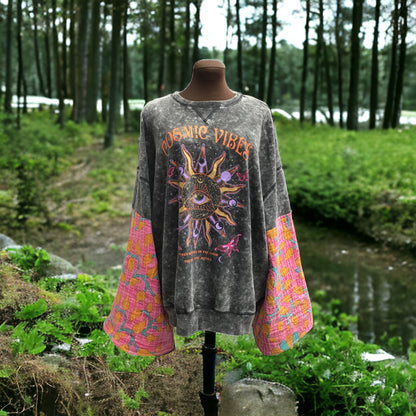 A mannequin with a sweatshirt in front of a forest.