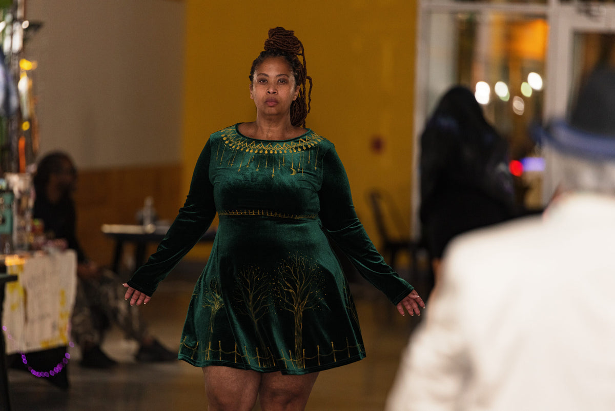 Woman wearing hand-painted green velvet dress