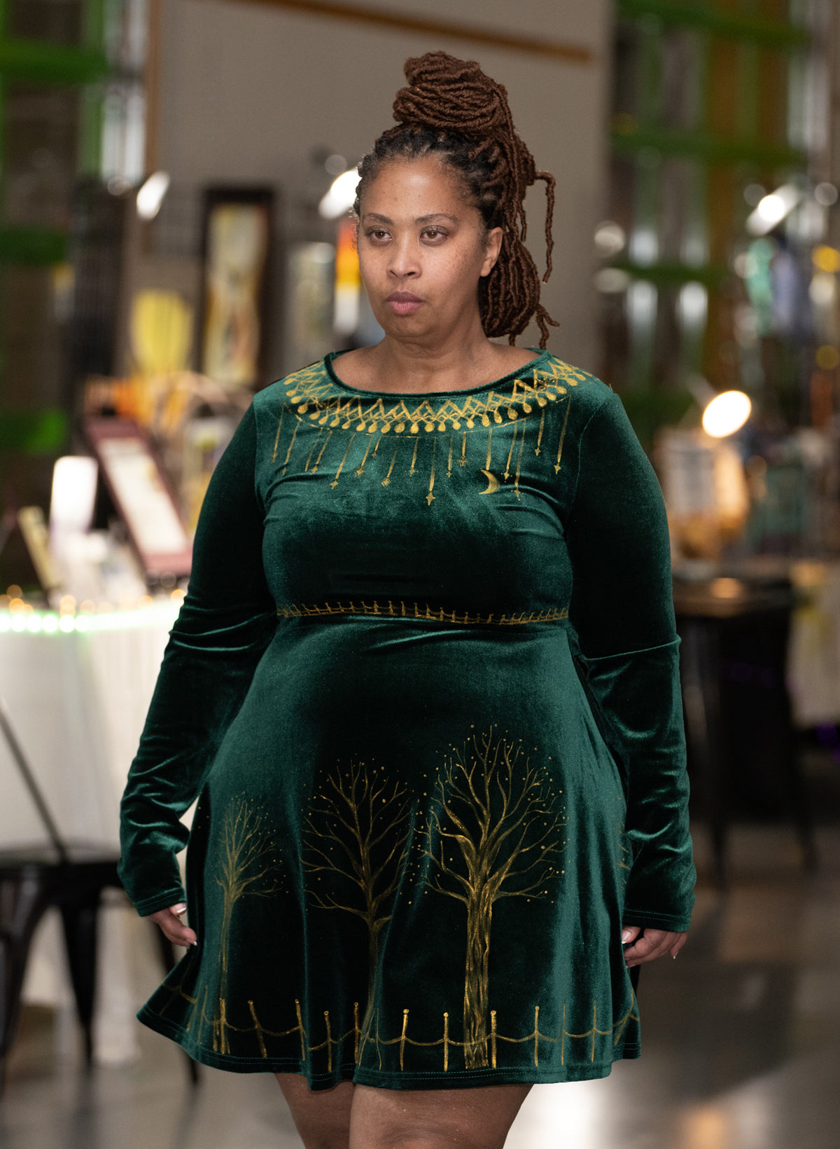 Woman wearing hand-painted green velvet dress