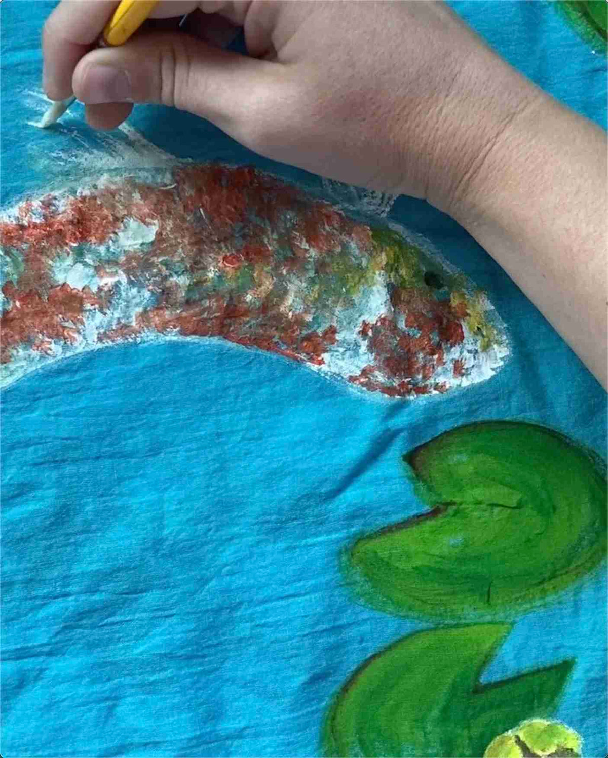 a person is drawing a picture on a piece of paper.