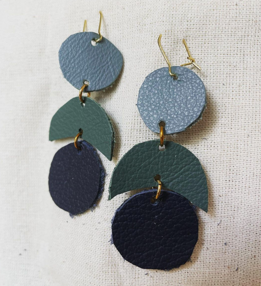 a pair of blue and green leather earrings.
