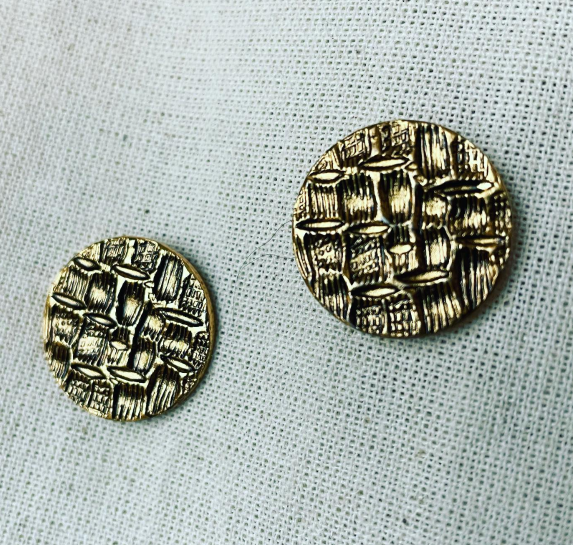 a close up of two buttons on a cloth.
