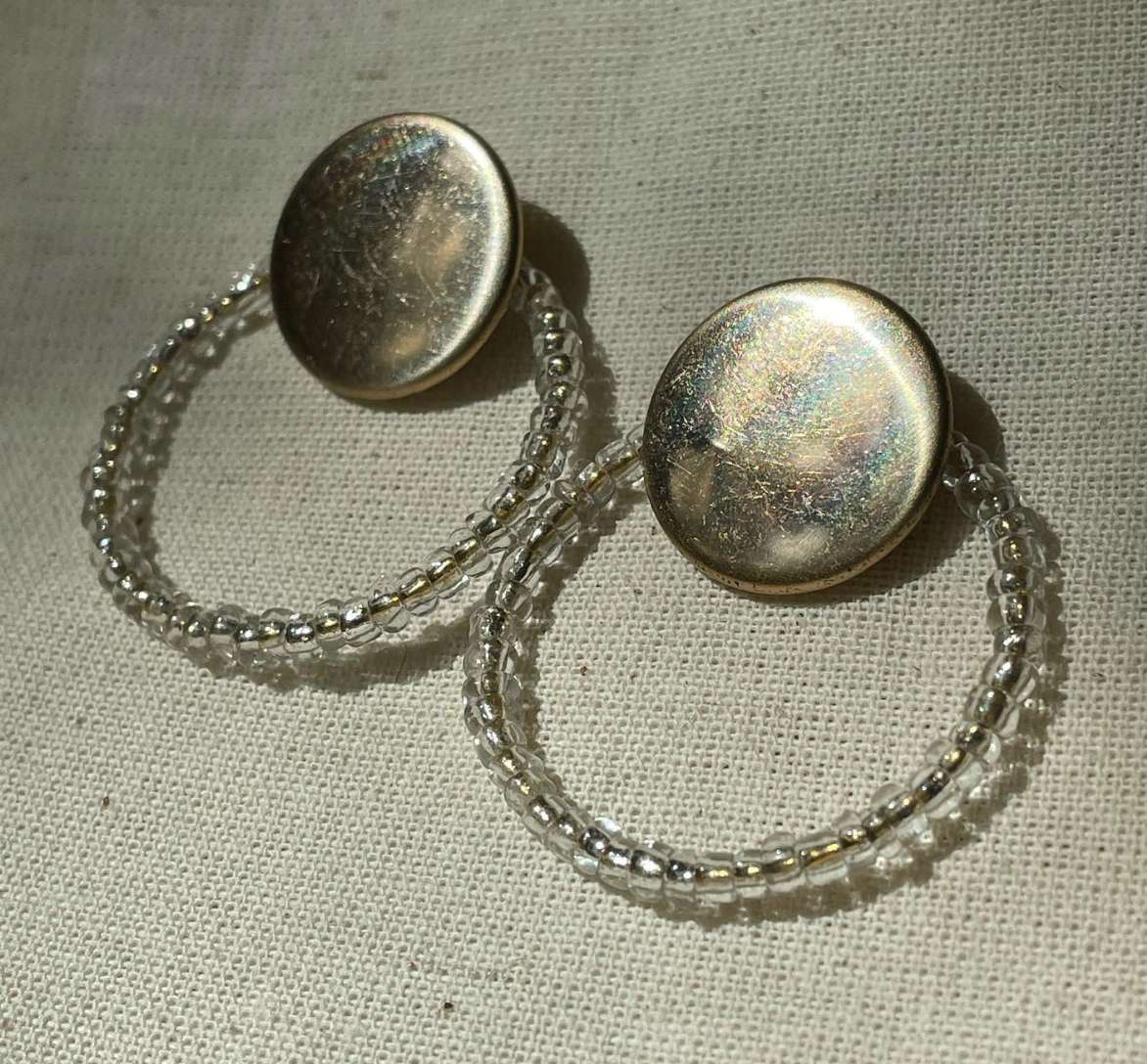 a pair of earrings sitting on top of a table.