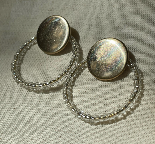 a pair of earrings sitting on top of a table.