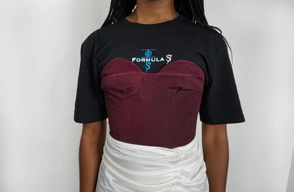 A woman wearing a Plum Bustier Strapless Crop Top with a white skirt.