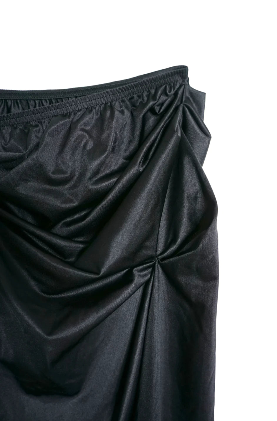 A close up of a LACE ICING Black Mini Skirt on a white background.