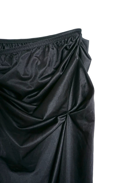A close up of a LACE ICING Black Mini Skirt on a white background.