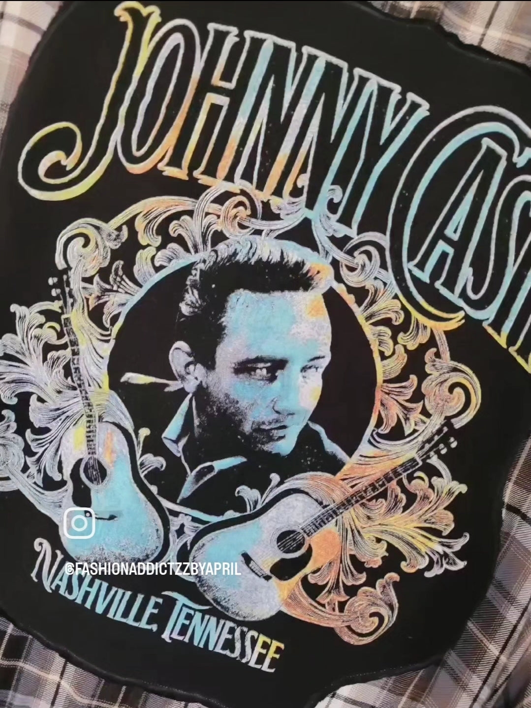 a black jacket with a picture of a man holding a guitar.
