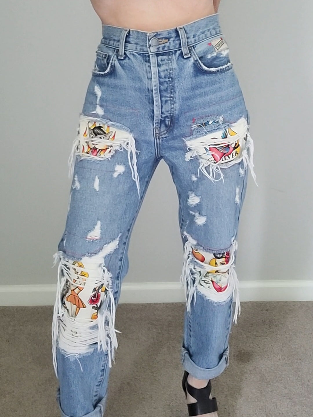 a woman in ripped jeans posing for a photo.