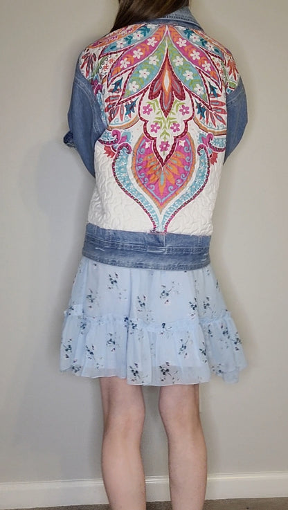 a girl wearing a denim jacket and a blue skirt.