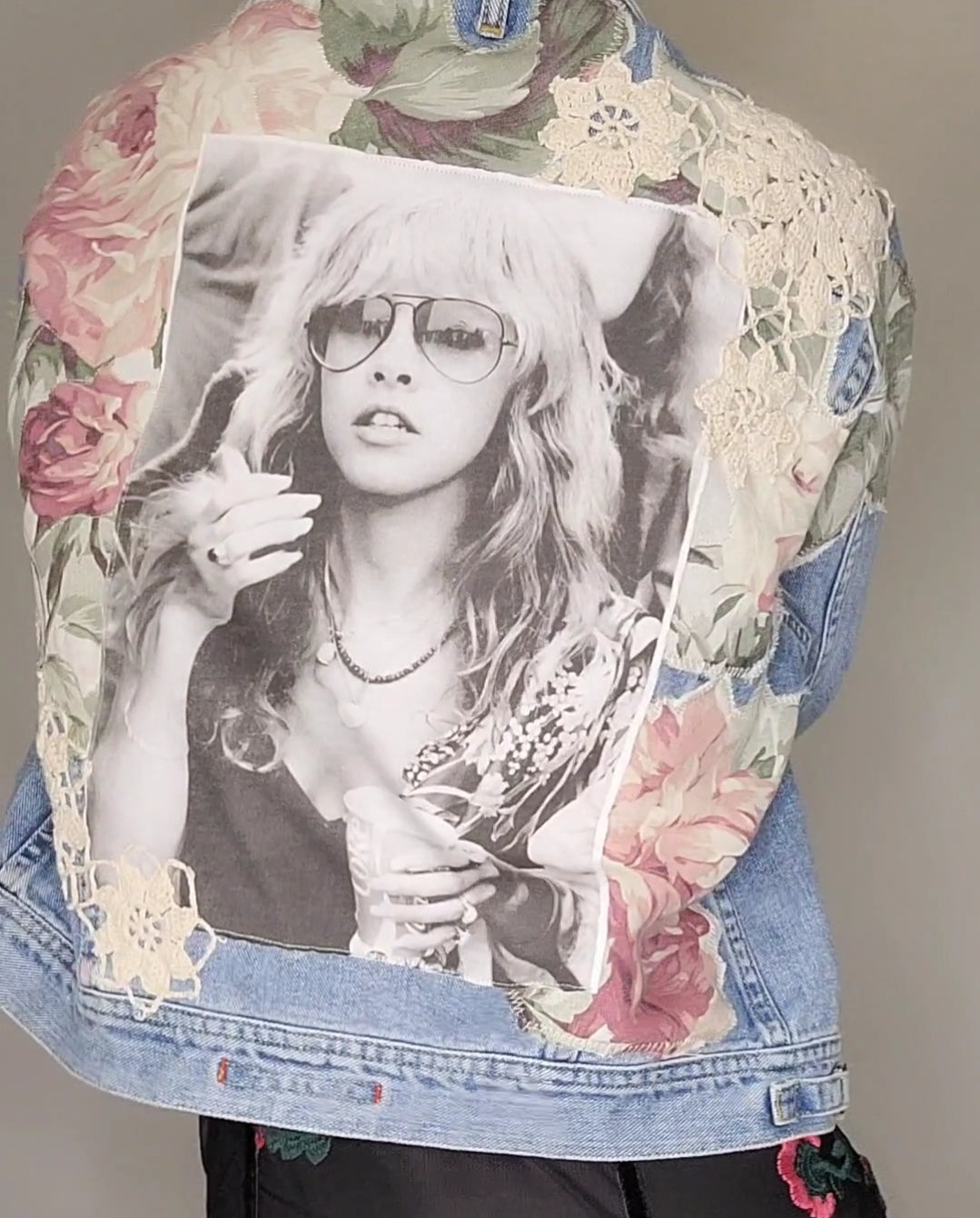 A denim jacket with a photo of a woman on it.