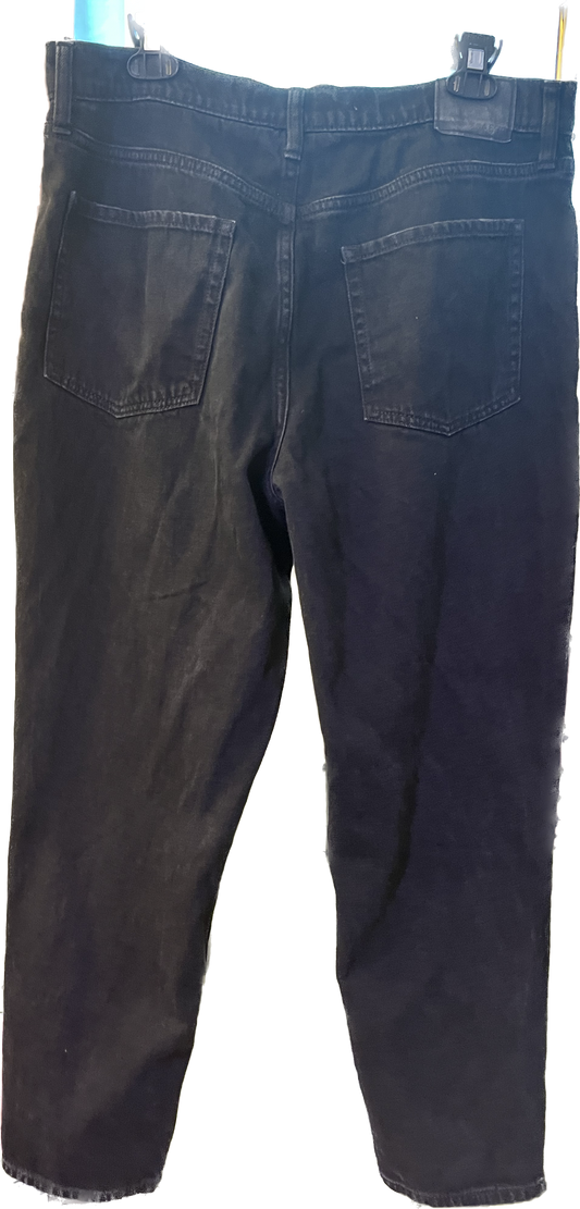 A pair of men's black jean shorts on a hanger.