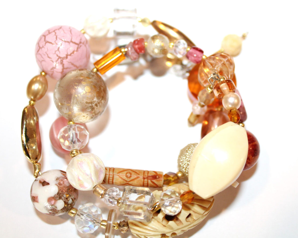 View of bracelet with ivory carved beads and warm tone crystals and pearls