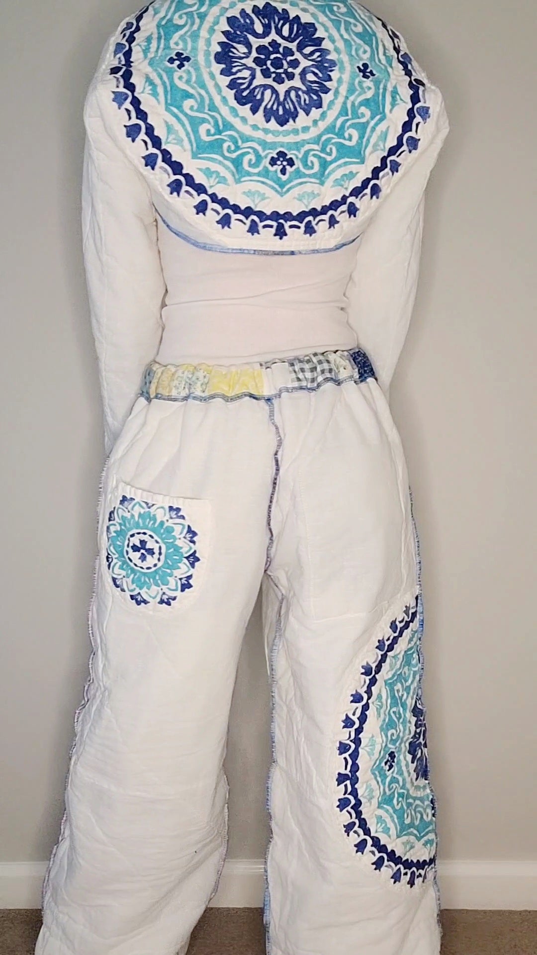 The back of a woman in a blue and white outfit.