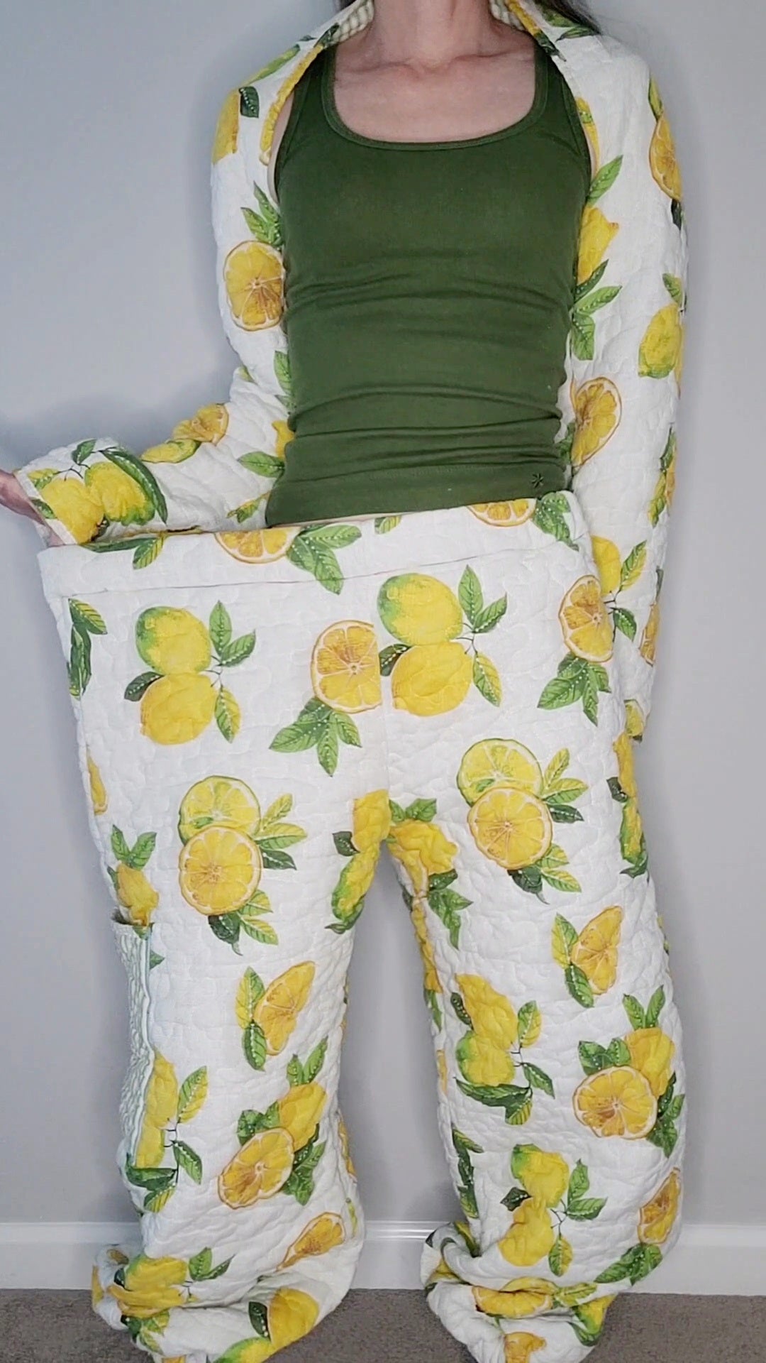 A woman wearing a lemon print pajama set.