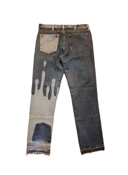 a pair of jeans with paint on them.