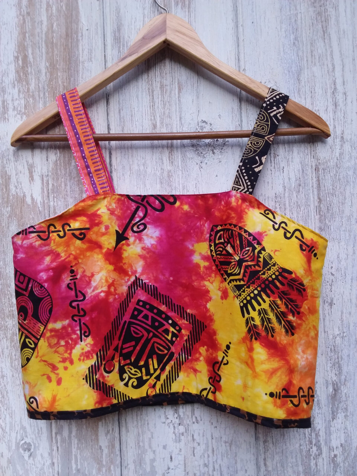 Colorful tie dye festival crop top with tribal faces