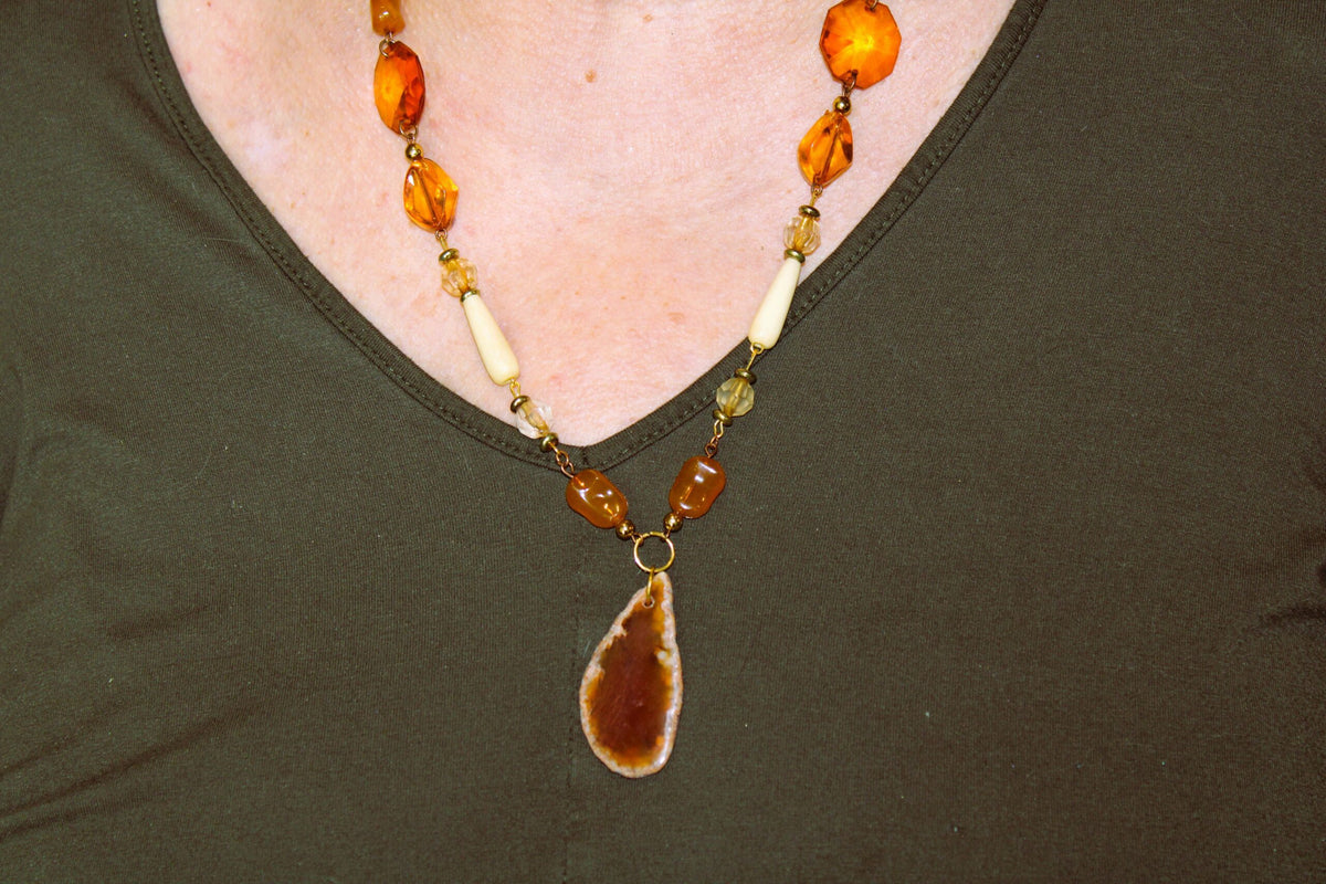 A woman wearing a necklace and earrings.