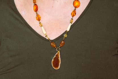A woman wearing a necklace and earrings.