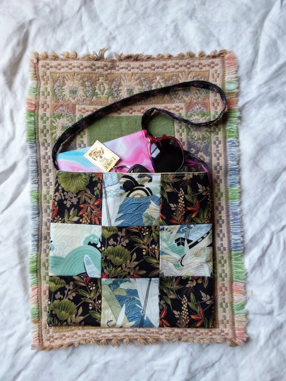 A bag with a patchwork pattern on it.