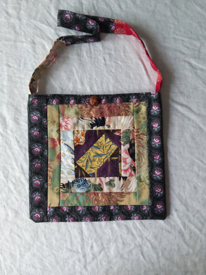 A bag with a patchwork pattern on it.