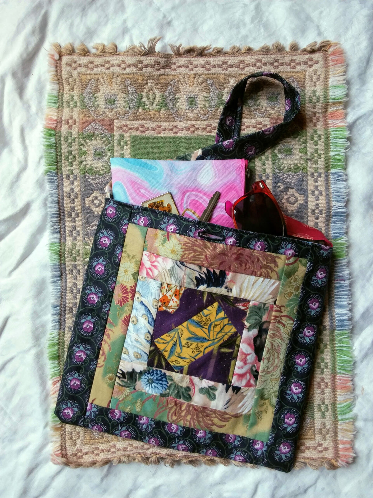 Recycled floral fabric quilted hand bag shown full of personal items