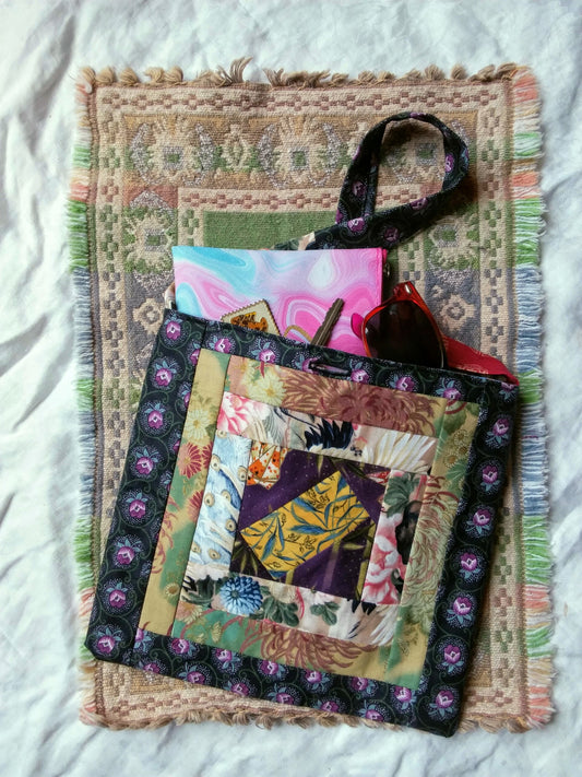 Recycled floral fabric quilted hand bag shown full of personal items