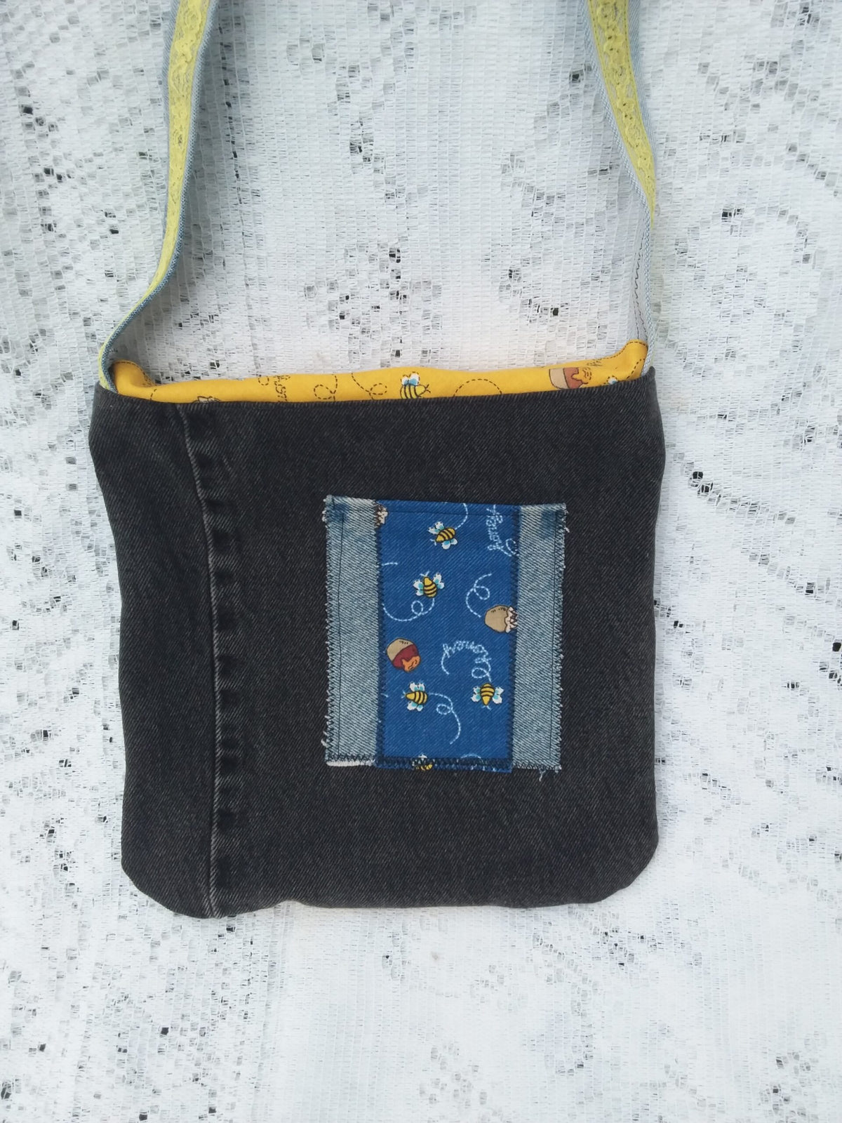 Bee Charmer handbag with upcycled denim and vintage honey bee fabric has a hand embroidered queen bee and whimsical bee button accent