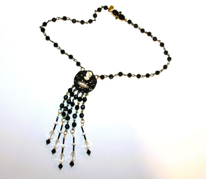 A black and white necklace with a beaded fringe.