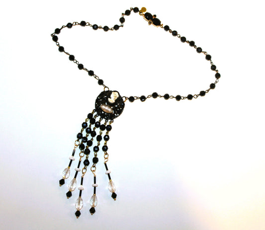 A black and white necklace with a beaded fringe.