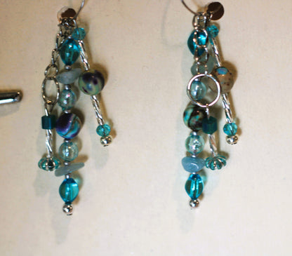 A pair of earrings hanging on a wall.