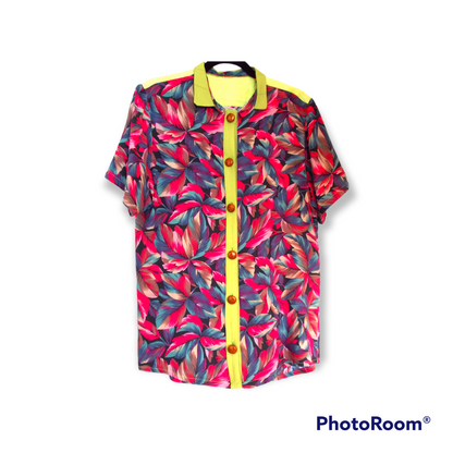 A Men's Floral Shirt hanging on a white wall.