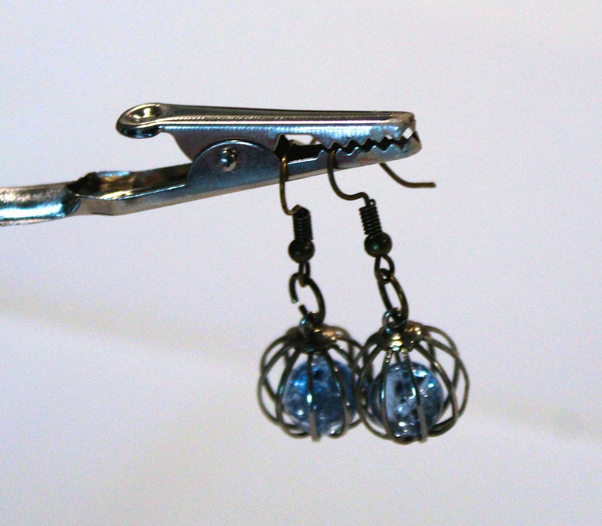 both caged blue bead earrings hanging up