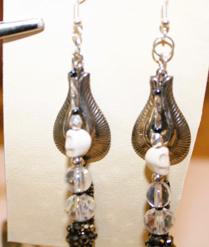 A pair of earrings with silver and black beads.